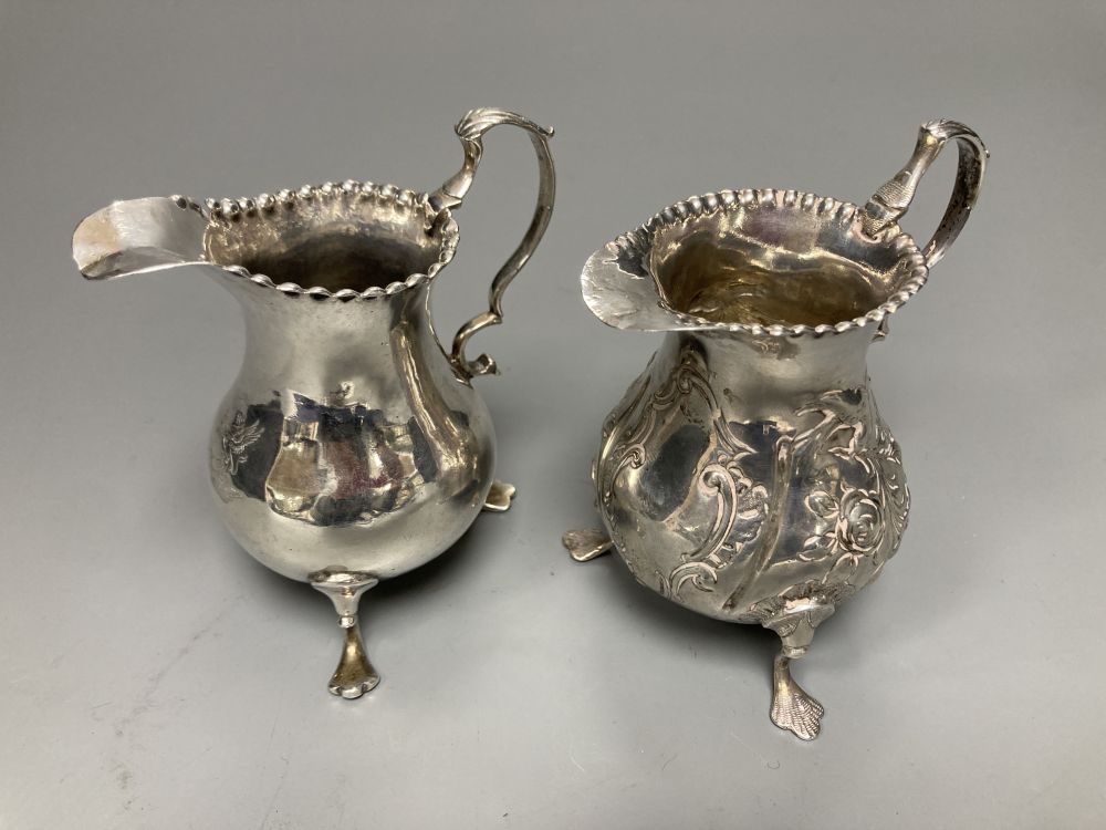 Two 18th century silver cream jugs, London, 1759 & 1768, the former with later embossed decoration,
